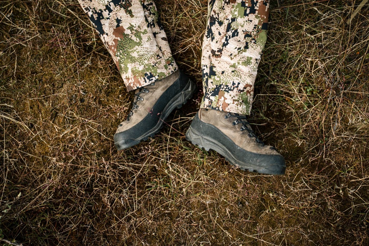 Hunting boots and camouflage trousers on the tundra