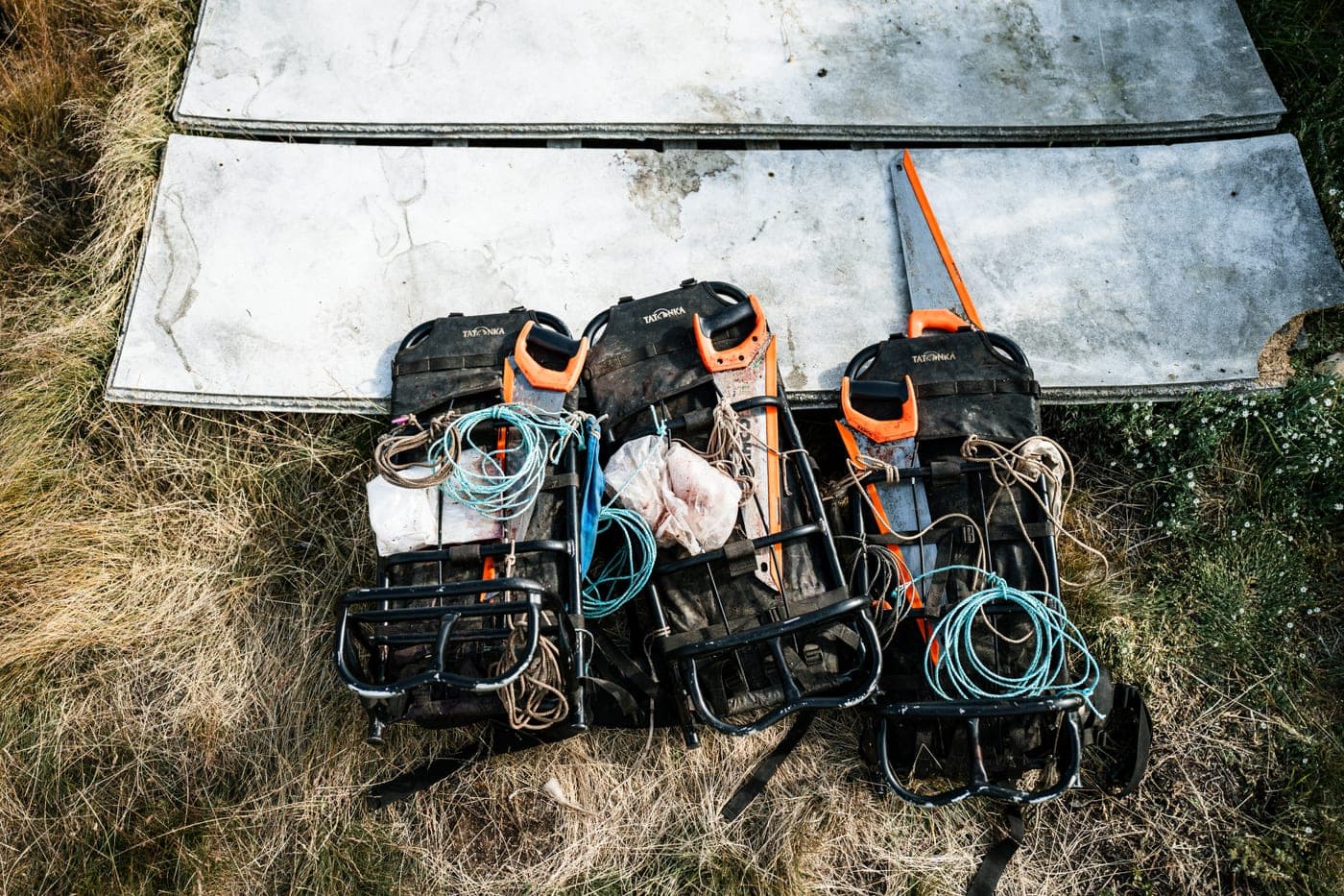 Bows and hunting gear laid out on the ground